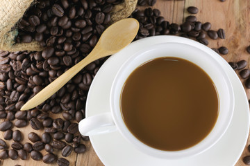 White coffee cup and roasted coffee beans.