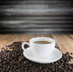 White coffee cup and roasted coffee beans.