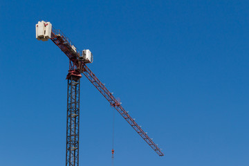 Tower crane on blue sky, Ukraine