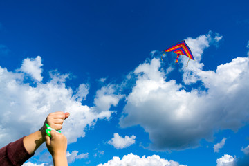 Hands holding kite