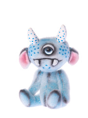 Cute stuffed animal one eyed blue monster toy isolated on a white background