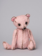 Classic pink teddy bear stuffed toy on a grey background