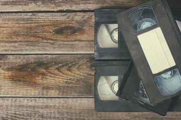stack of VHS video tape cassette over wooden background. top view photo

