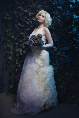 Fototapeta premium Beautiful gothic woman in white dress and roses