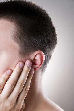 Man with a earache. Pain in the human body
