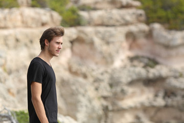 Portrait of a man exploring and looking away in the mountain