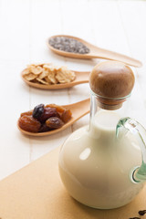 Set of raisins, whole wheat grain flakes and chia seeds in woode