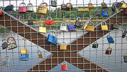 Padlocks on the balustrade of a bridge as a symbol of love