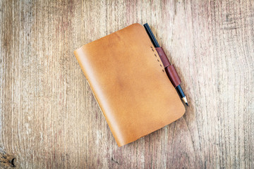 brown Leather notebooks on wooden background