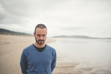 Man looking down on the beach