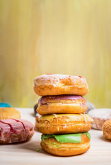 fresh baked  homemade colorful donuts on light background