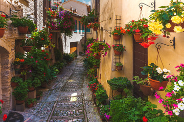 Fototapeta na wymiar Floral street in central Italy, in the small Umbrian medieval to