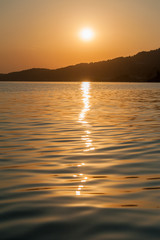 Fototapeta na wymiar Sunset at sea level, tranquil water