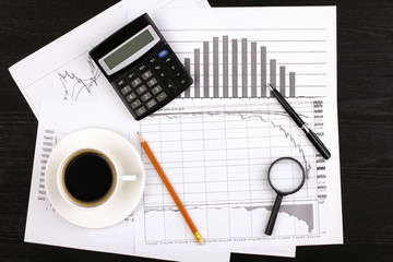 graphics, cup of coffee, calculator and pen