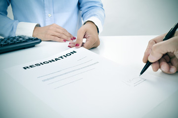 man signing a resignation document