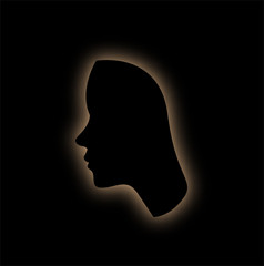 Outline of the form of a womans face in the dark