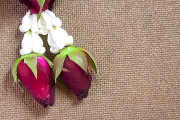 Thai traditional jasmine, rose and orchid garland on wooden background.