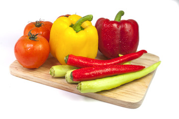 Mixed collection of fresh organic vegetables isolated on a white background. Healthy vegetarian food with wooden bowl of salad.