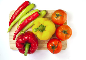 Mixed collection of fresh organic vegetables isolated on a white background. Healthy vegetarian food with wooden bowl of salad.