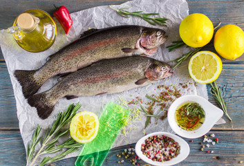 Two fresh rainbow trout with lemon, rosemary and spices