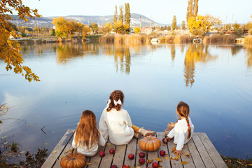 Kids playing near the lake in autumn