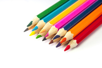 Line of colored pencils isolated on white background close up