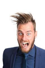 Crazy businessman with big hair screaming. Wearing a blue suit and blue tie. White background.