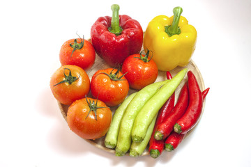 Mixed collection of fresh organic vegetables for healthy vegetarian food isolated on a white background.
