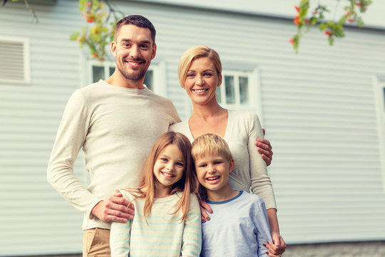 Happy Family In Front Of House Outdoors