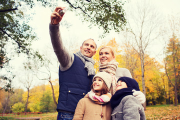 happy family with camera in autumn  park