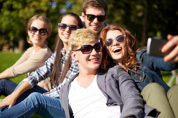 students or teenagers with smartphone at campus