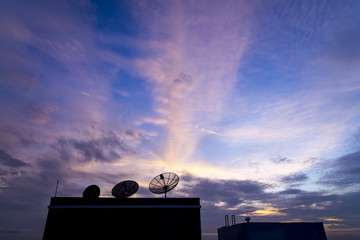 silhouette of Satellite dish in sunset sky and cloud - communica