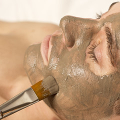 man receiving spa facial treatment