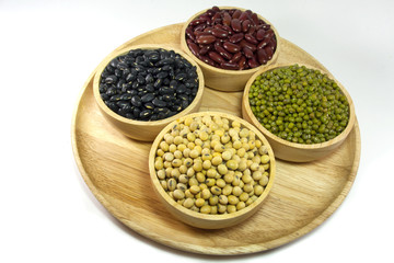 Mixed beans and lentils in the wooden bowl isolated on white background. mung bean, soybean, red kidney bean , black bean ,red bean,green bean.