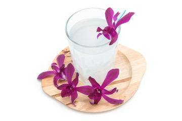 Fresh coconut drink with orchid flower on white background