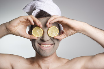man with a mud mask on this face