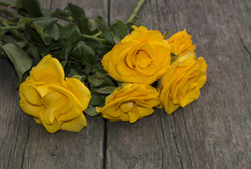 beautiful bouquet of yellow roses on a wooden table