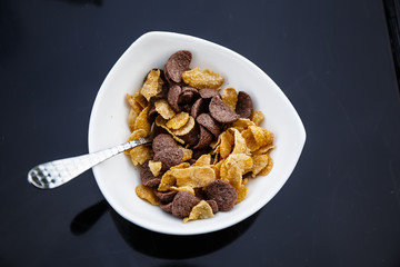 Cornflakes in a bowl on the table.