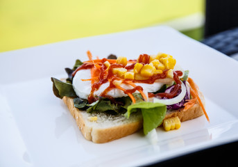 Salad bread and eggs on the table