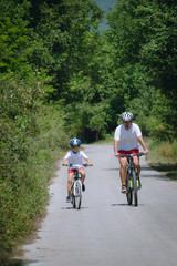 Naklejka premium Father and son cycling