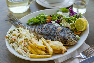 Bream with potato, rice and salad