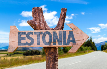 Estonia wooden sign with road background