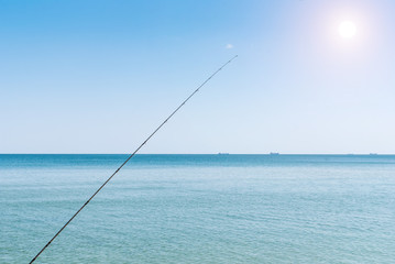 Fishing rods on the background of blue water