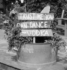 Vintage wooden sign with trust me you can dance,being used for a wedding