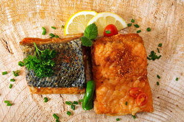 Salmon steak with lemon  on wooden background.
