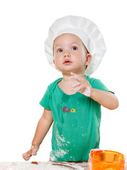 Cute kid in a chef's hat preparing the pizza