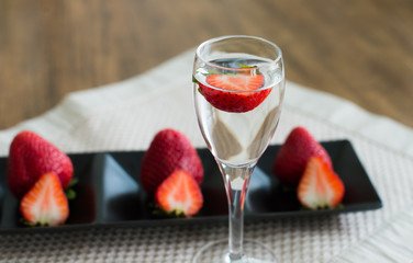 decoration strawberry put on the wood table with fresh strawberries in the glass of water and serving
