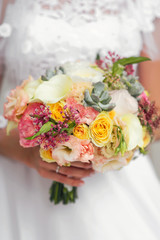 Wedding bouquet at bride's hands