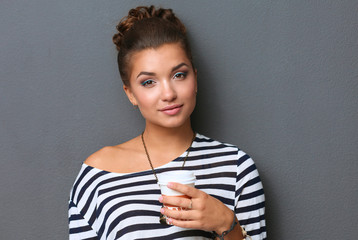 Portrait of young woman with cup tea or coffee