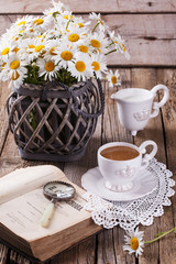 Coffee with milk,Breakfast in the morning with a book and flowers.selective focus